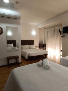 a hotel room with two beds and a mirror at São Neutel in Chaves