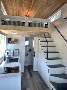 a tiny house with a staircase and a sink at The Eagle’s View (Tiny Home 4) in Bellevue