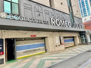 a building with two garage doors and a sign on it at Daegu Romeo and Juliet in Daegu +5 photos