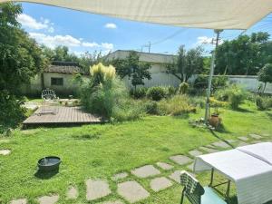 a garden with a table and a patio at Jangheung Stay 1978 in Jangheung