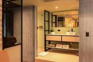 a bathroom with a sink and a mirror at 5Q HOUSE Zona G in Bogotá +38 photos