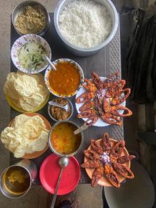 a table topped with lots of different types of food at Amber Mount Resorts in Kanthalloor