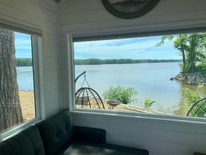 a window in a room with a view of a lake at The Eagle’s View (Tiny Home 4) in Bellevue +4 photos
