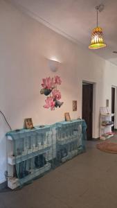 a room with a fireplace with pink flowers on the wall at Laxmi Happy Home in Querim Goa in Querim