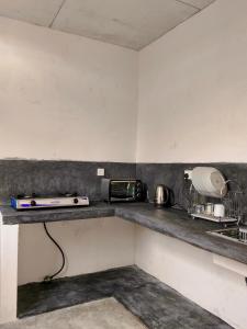 a kitchen with a counter with a toaster and a appliance at Kumara villa in Hikkaduwa