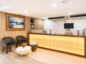 a waiting room with two chairs and a counter at The E-Hotel Makati in Manila +5 photos