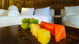 a plate of fruit on a table in a hotel room at Hotel Boutique Sylvie in Mahahual
