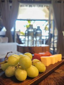 a tray with grapes and cheese on a table at Hotel Boutique Sylvie in Mahahual +33 photos