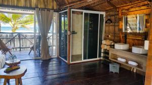 a bathroom with two sinks in a room with a balcony at Hotel Boutique Sylvie in Mahahual