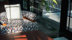 a checkered chair sitting in front of a window at Sugar Marina Hotel - FASHION - Kata Beach in Kata Beach +18 photos