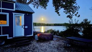 a house sitting next to a body of water at The Eagle’s View (Tiny Home 4) in Bellevue