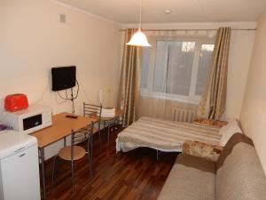 a living room with a couch and a table at Beach Ranna Apartment Kopli in Tallinn