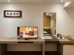 a computer monitor sitting on a wooden desk at The E-Hotel Makati in Manila