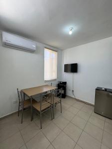 a dining room with a table and a television at Equipped house in Salinas industrial zone in Ciudad Satelite del Norte