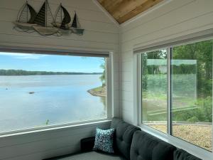 a screened in porch with a view of the water at The River's Edge (Tiny Home 3) in Bellevue