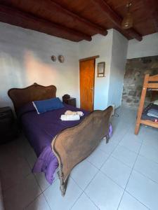 a bedroom with a bed with a blanket on it at Casa los Molles Hostel in Maimará