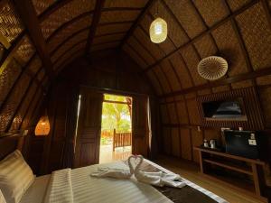 a bedroom with a bed in a wooden room at Artala Villa & Restaurant in Besakih