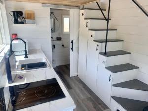 a tiny house with a sink and stairs at The River's Edge (Tiny Home 3) in Bellevue +8 photos