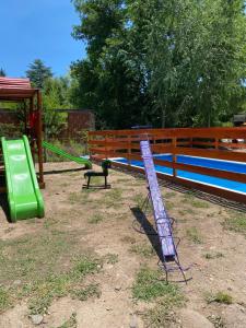 a playground with a slide and a swing set at Cabañas Frago in Villa Amancay