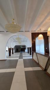 a large room with a dance floor and a chandelier at Wanderlust at Golden Sun in Diani Beach +44 photos