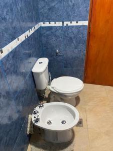 a bathroom with a toilet and a sink at Cabañas Frago in Villa Amancay +15 photos