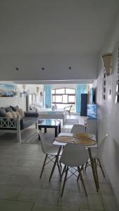 a living room with a table and chairs and a couch at Wanderlust at Golden Sun in Diani Beach
