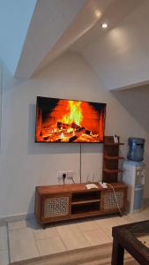 a flat screen tv hanging on a wall at Wanderlust at Golden Sun in Diani Beach