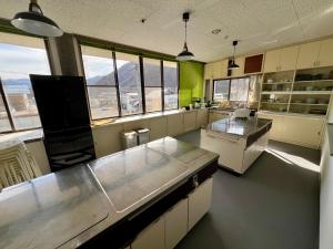 a large kitchen with a view of a mountain at ヨゴダステイアンドリトリート Yogoda Stay & Retreat in Ina