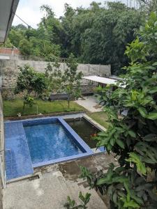 a swimming pool in a yard with a garden at Nanda Harum Villa in Sangyang