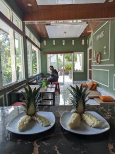 two plates with pineapple on them on a counter in a kitchen at Nanda Harum Villa in Sangyang