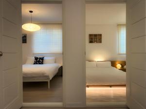 a bedroom with a bed and a window at Seongsu#3beds#10min seongsu station#2min walk from yongdap station line2 #local food hot spot#DDP#KSPO in Seoul