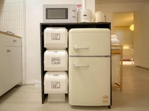 a kitchen with two refrigerators and a microwave on a counter at Seongsu#3beds#10min seongsu station#2min walk from yongdap station line2 #local food hot spot#DDP#KSPO in Seoul