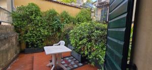a small white table and chair sitting on a patio at Cavour rooms in Verona +18 photos