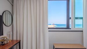 a room with a window with a view of the ocean at Yangyang J Ocean View in Yangyang