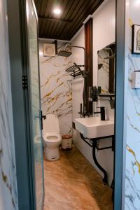 a bathroom with a toilet and a sink at Angels Homestay & Coffee - Măng Đen in Kon Von Kla +162 photos
