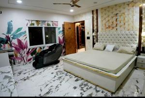 a bedroom with a bed and a tv in a room at The White Lilly in Noida