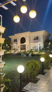 a large building with lights in front of it at The White Lilly in Noida