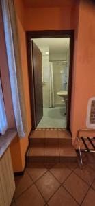 a bathroom with a walk in shower and a glass door at Cavour rooms in Verona
