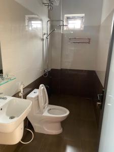 a bathroom with a white toilet and a sink at Nhà của Mầm in Ninh Binh