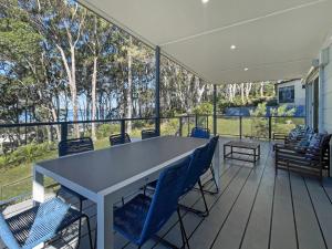 a screened porch with a table and chairs at Pet-Friendly 3-Bed Coastal Gem Near Long Beach in Long Beach