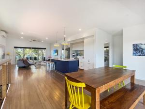 a kitchen and living room with a wooden table and yellow chairs at Pet-Friendly 3-Bed Coastal Gem Near Long Beach in Long Beach