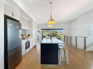 a kitchen with a black refrigerator and a counter top at Pet-Friendly 3-Bed Coastal Gem Near Long Beach in Long Beach