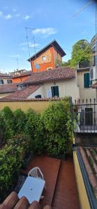 a patio with a white table and chairs in front of a building at Cavour rooms in Verona
