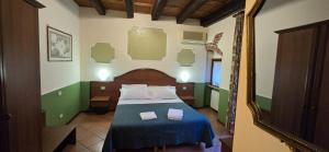 a bedroom with a bed with two towels on it at Cavour rooms in Verona