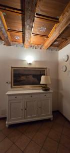 a room with a table with a lamp on a wall at Cavour rooms in Verona