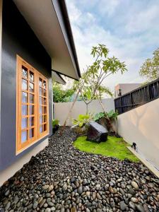 a house with a window and a gravel yard at Lepen Home in Ngabean