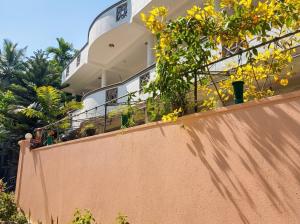 a house with yellow flowers on a wall at Villa Dream D in Hikkaduwa