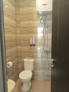 a small bathroom with a toilet and a shower at Shania home in Bogor +13 photos