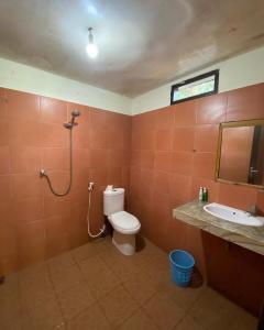 a bathroom with a toilet and a sink at meno smile cottages 2 in Gili Meno