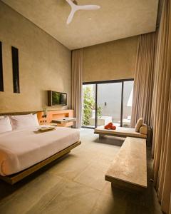 a bedroom with a bed and a large window at Amorita Resort Palawan in Puerto Princesa